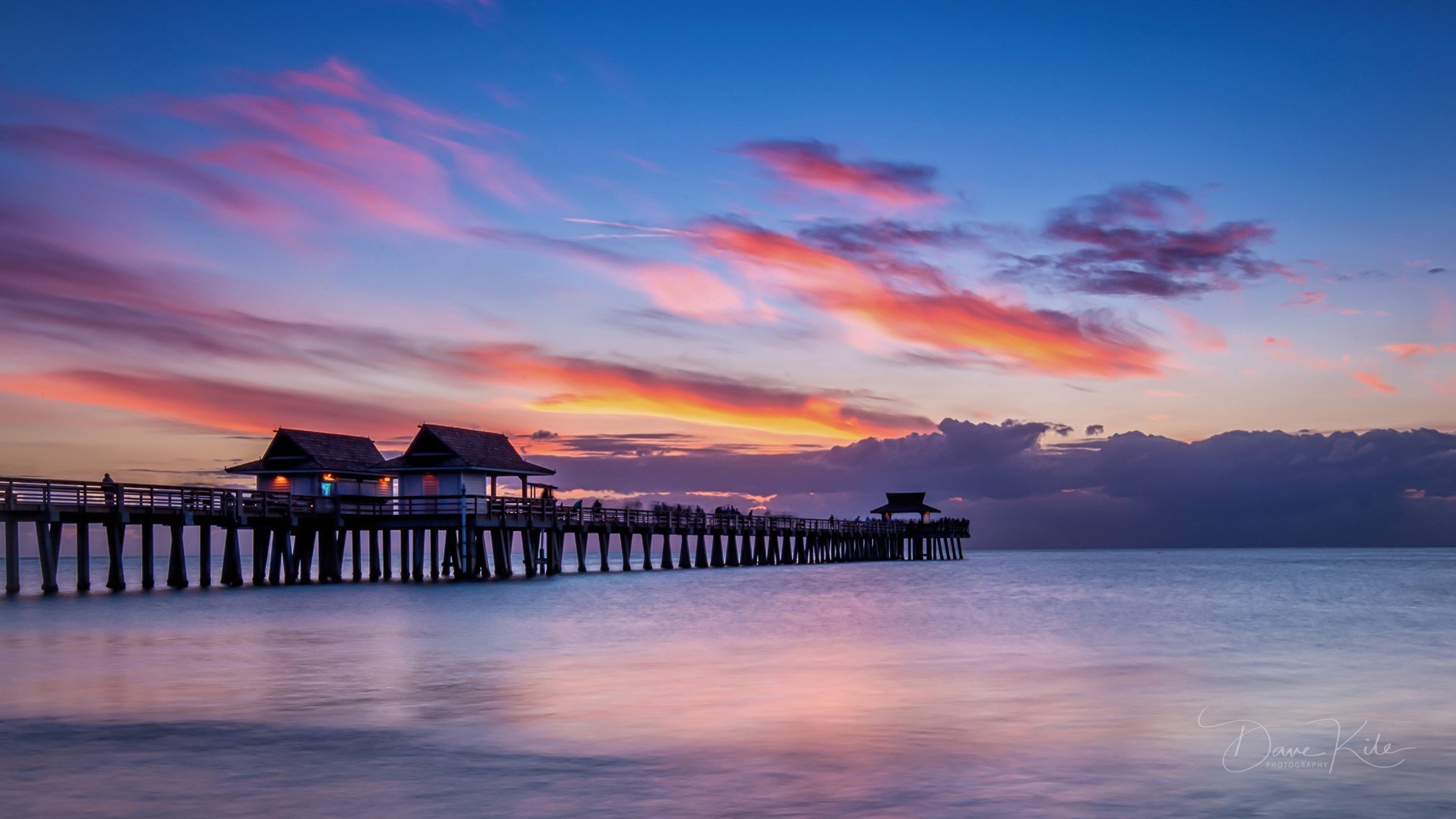 Naples pier beneath a colorful sunset